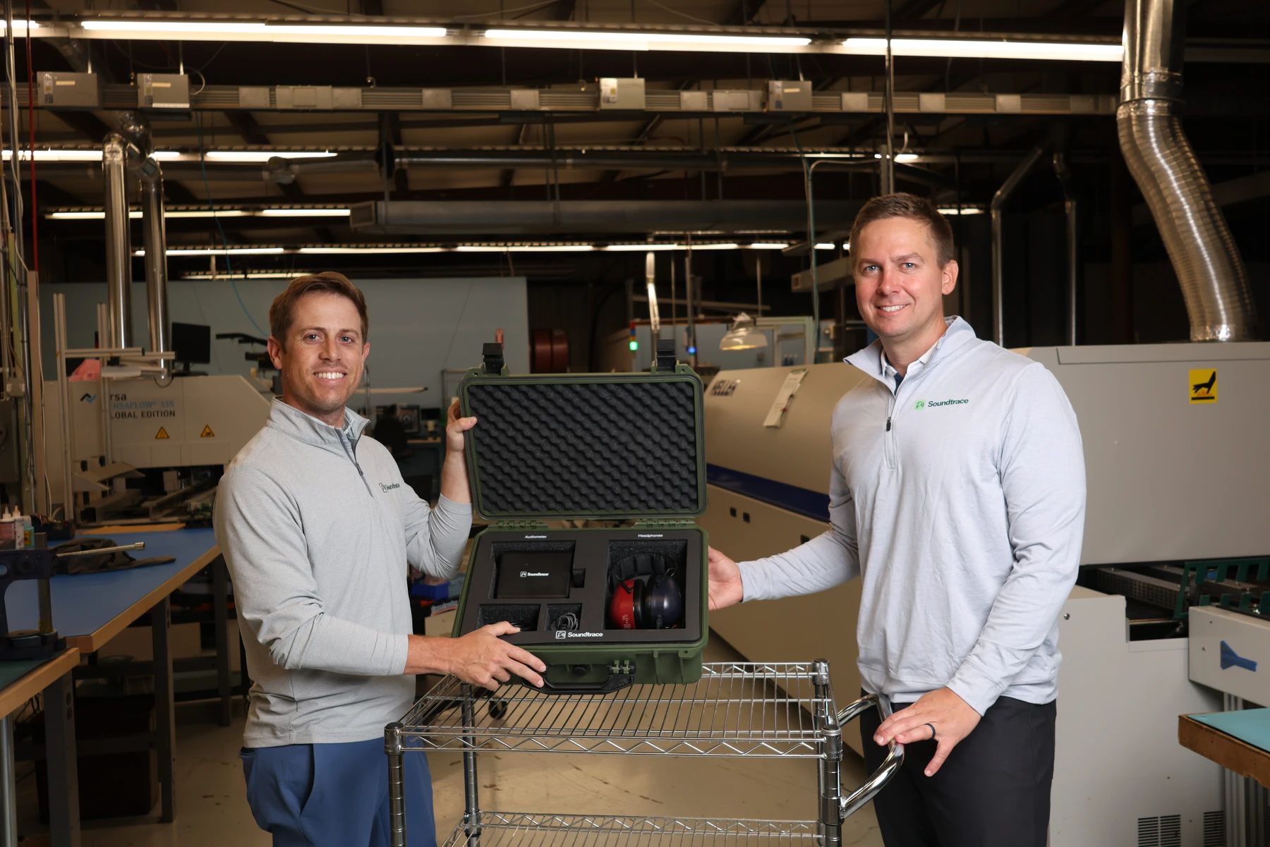 Soundtrace team members presenting a complete audiometric testing kit at the Middletown, Ohio manufacturing facility